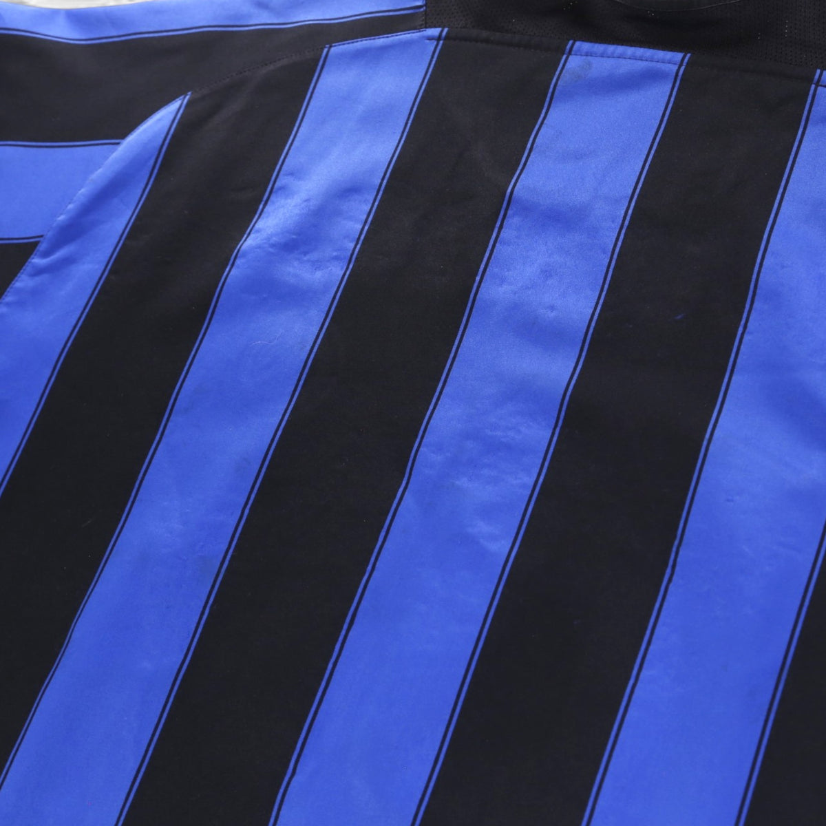 Close-up of the black and blue striped fabric on the Inter Milan home shirt