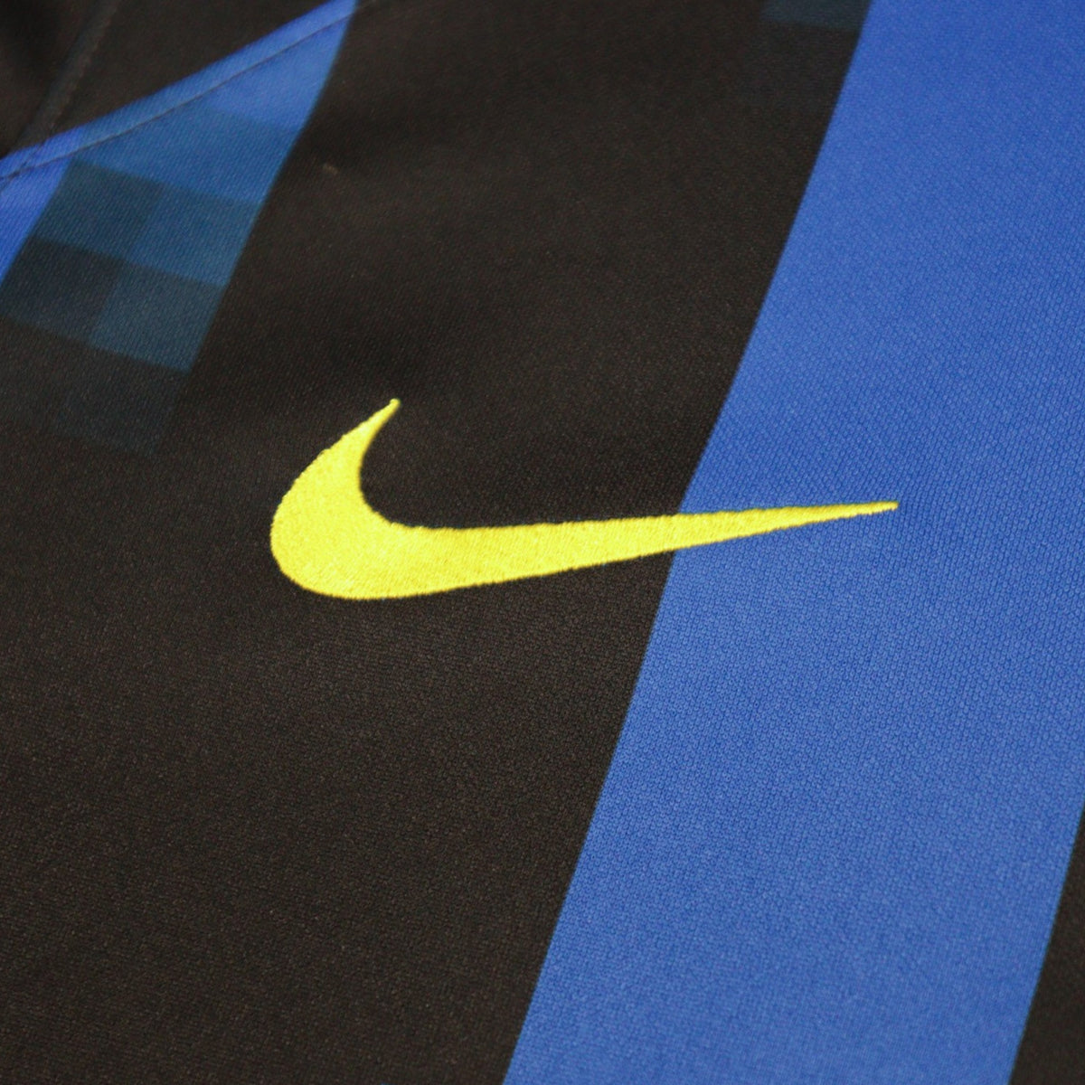 Close-up of the yellow Nike swoosh on the shirt