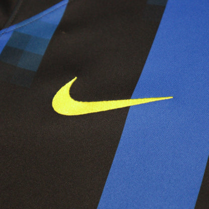 Close-up of the yellow Nike swoosh on the shirt