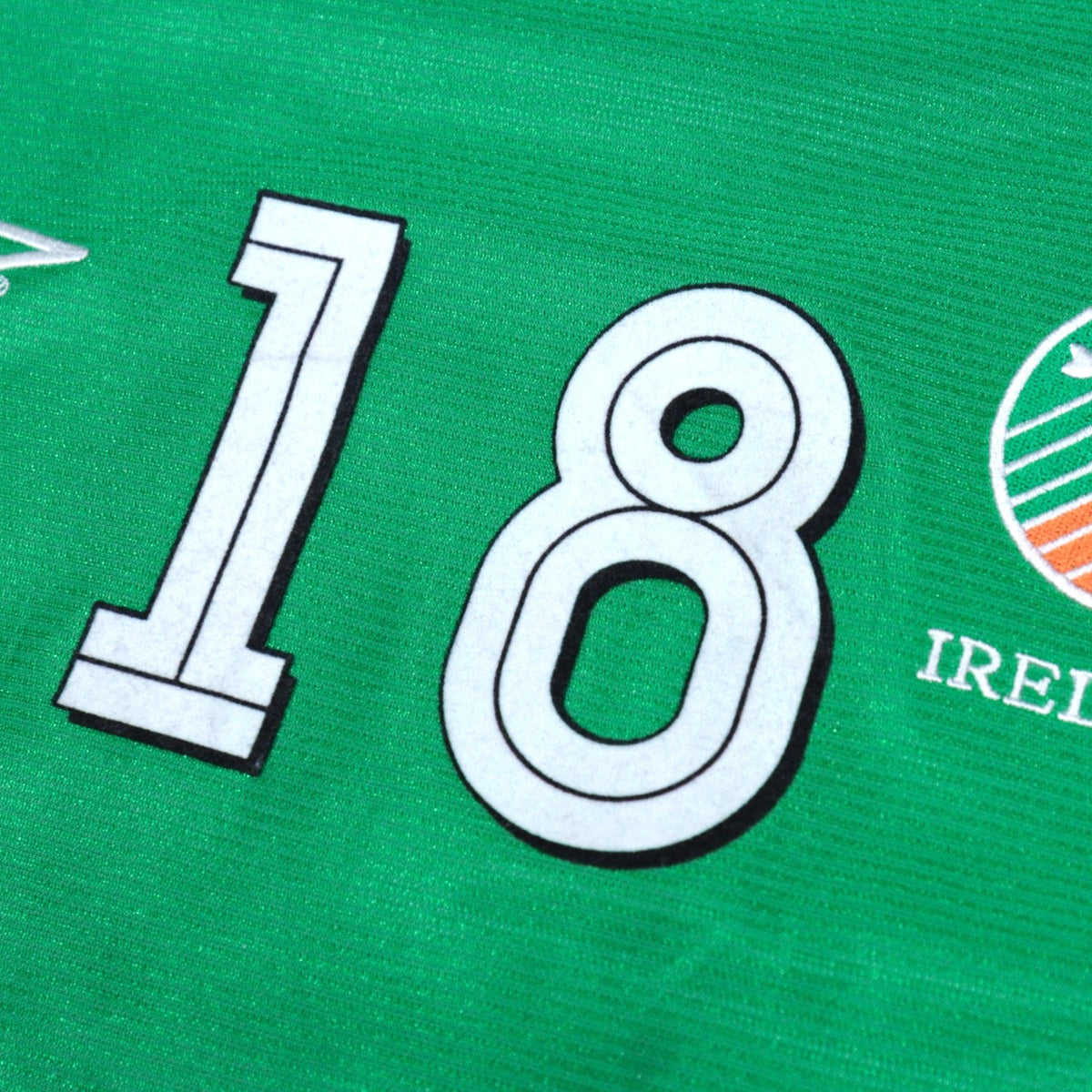 Close-up of number 18 printing beside the FAI Ireland crest
