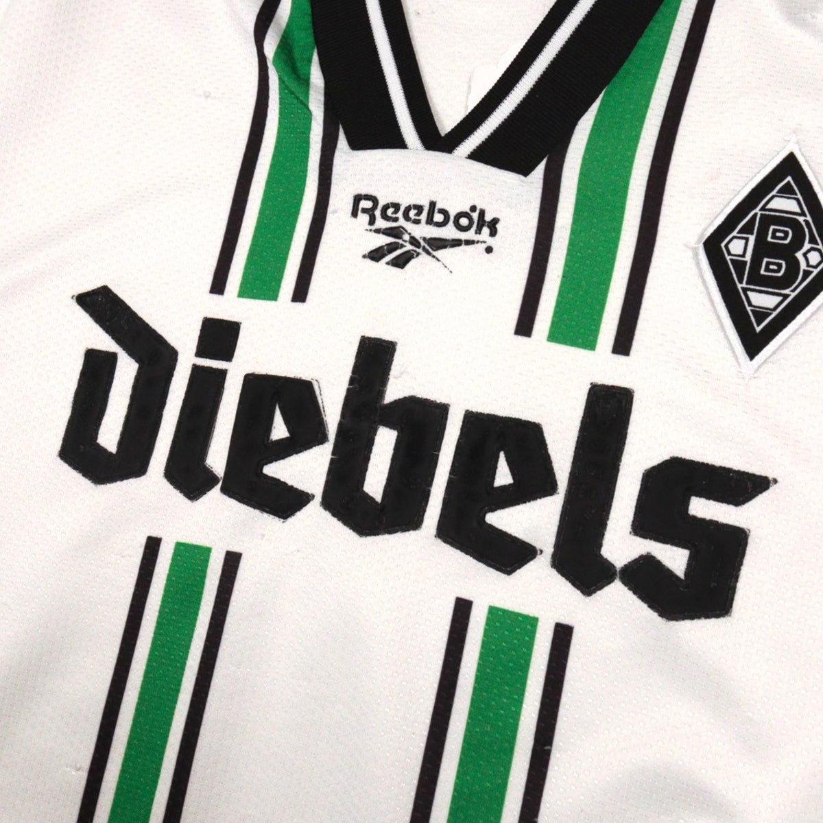 Close-up of Reebok logo, Diebels sponsor and club crest on the chest