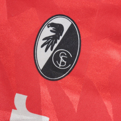 Close-up of the SC Freiburg eagle crest on the shirt's chest.