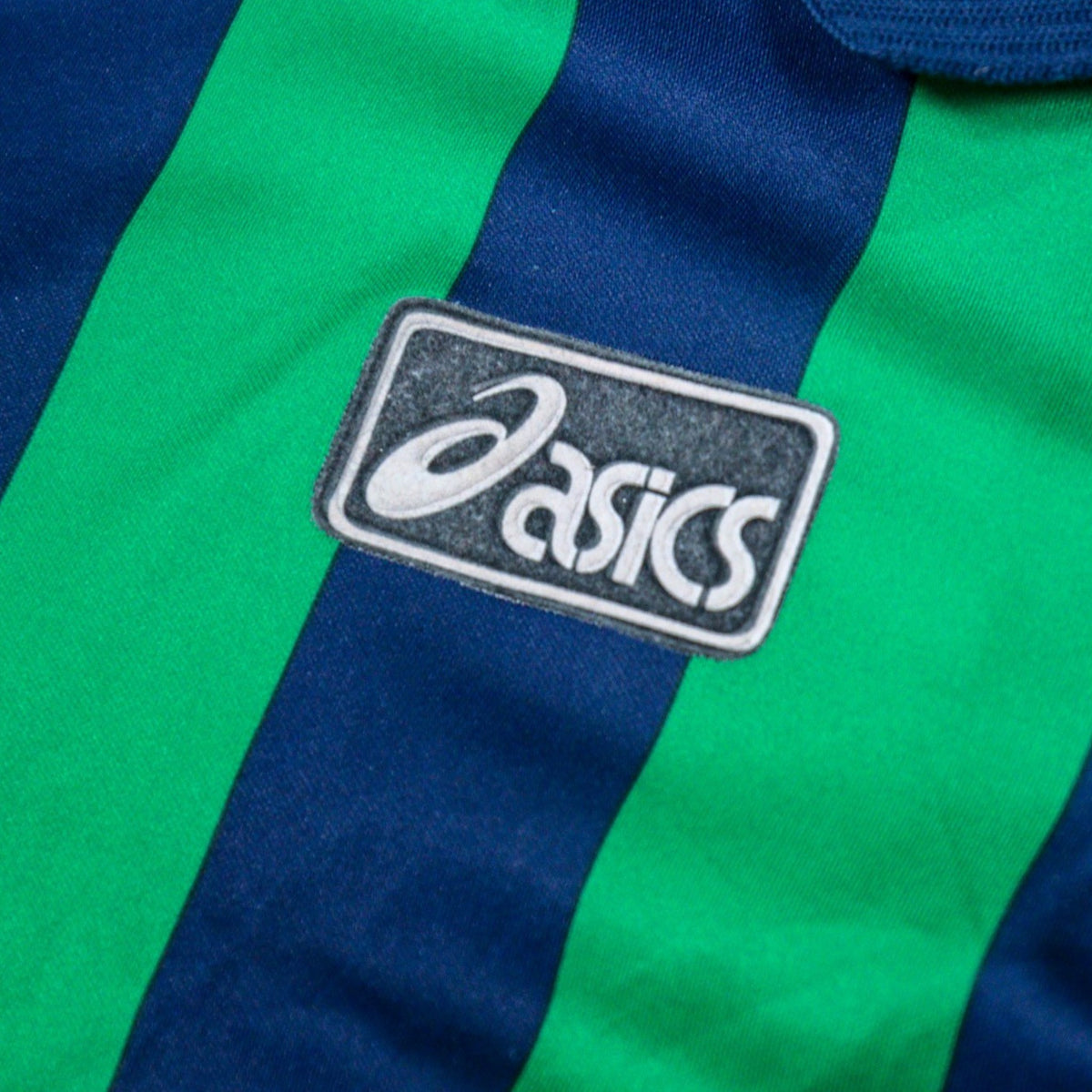 Close-up of the Asics logo on the chest