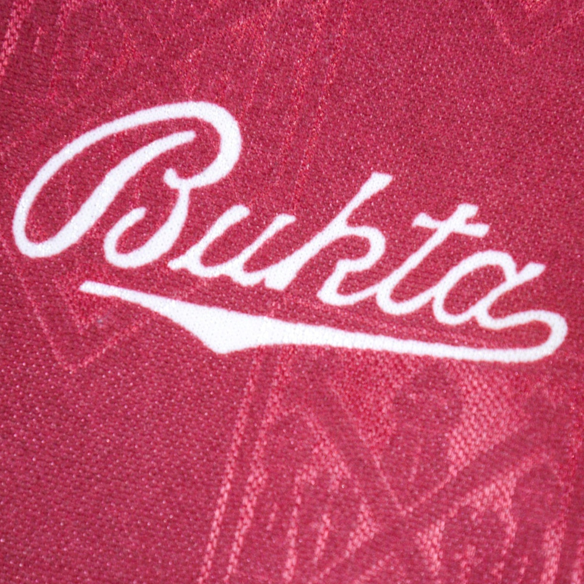 Close-up of the Bukta manufacturer logo on the shirt